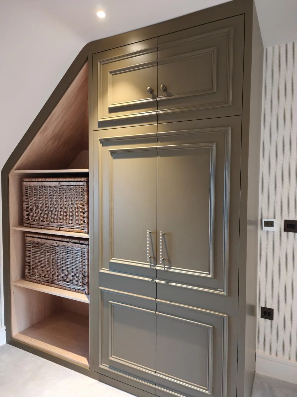 Open shelves with baskets beneath the slope
