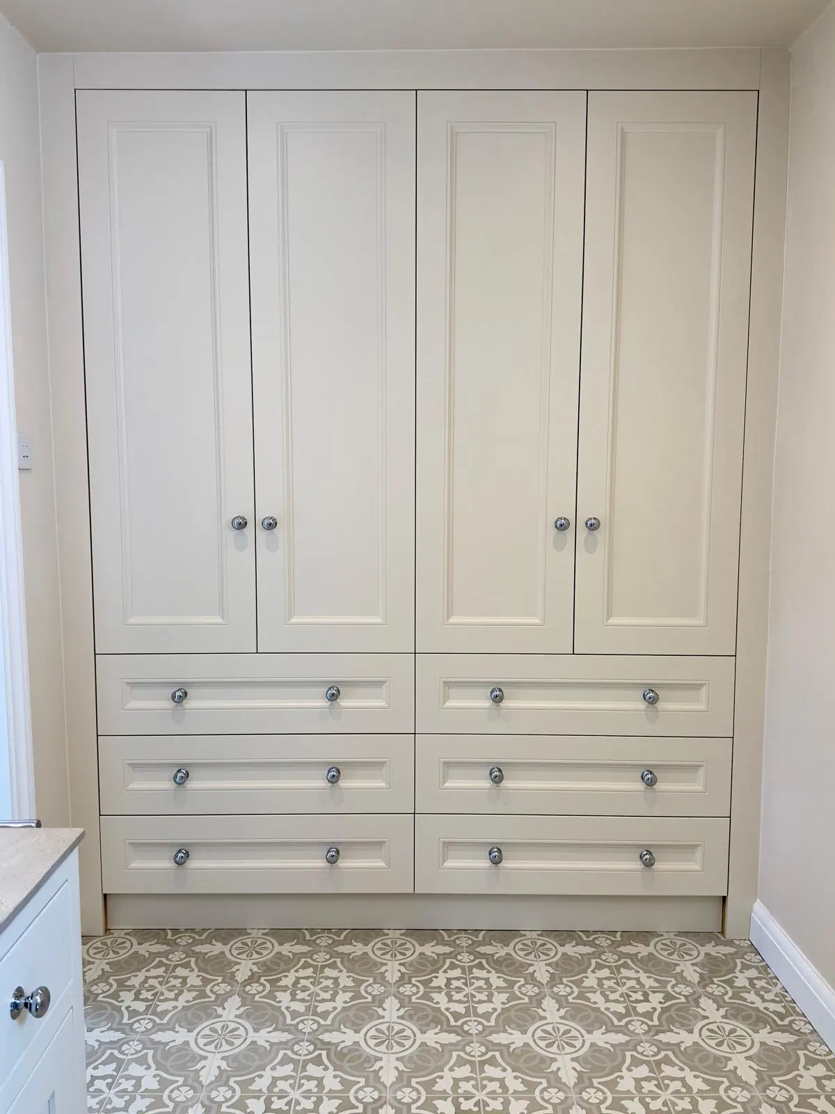 En-suite wardrobe with drawers and painted panel doors